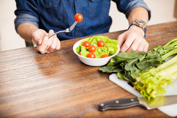 Man eating a salad up close