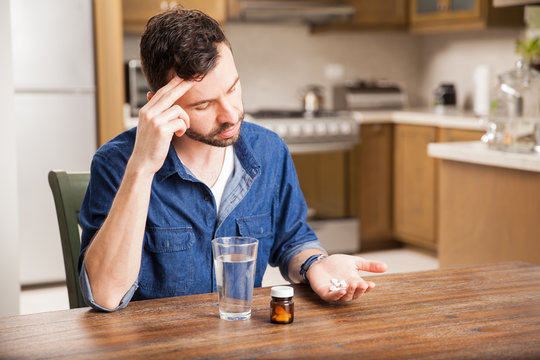 Hungover Guy Taking Some Pills