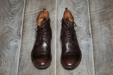 Vintage men's shoes on an old wooden floor
