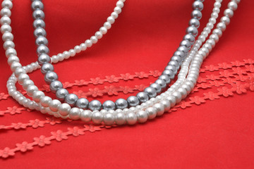 Pearl threads on red velvet 