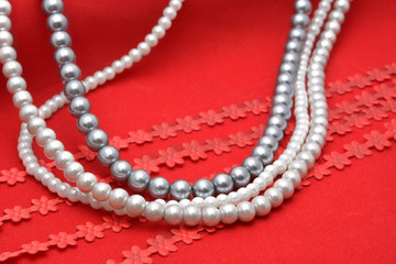 Pearl threads on red velvet 