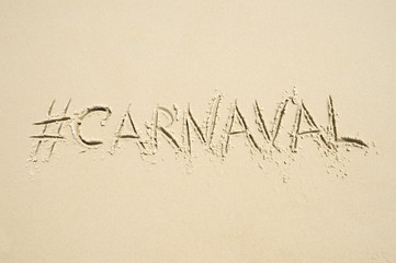 Hashtag social media message for carnival (spelled carnaval in Portuguese) written in smooth sand on the beach in Rio de Janeiro, Brazil