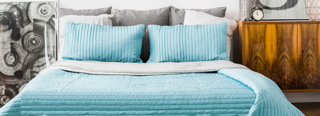 Fototapeta Turquoise cushions and bedspread obraz