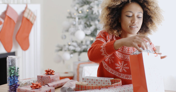 Pretty Young Woman Wrapping Xmas Presents