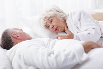 Mature marriage arguing in bed