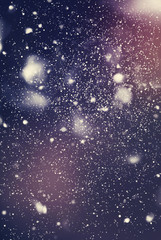 Snow Falling from Dark Night Sky. Abstract Background