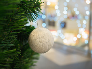 Fototapeta na wymiar White Christmas ball on Christmas tree, selective focus