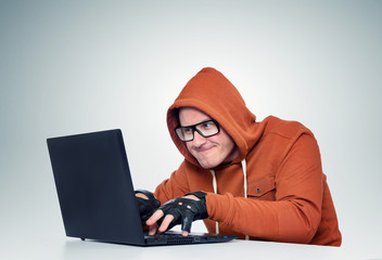 Hacker in glasses with a laptop. File contains a path to isolation.