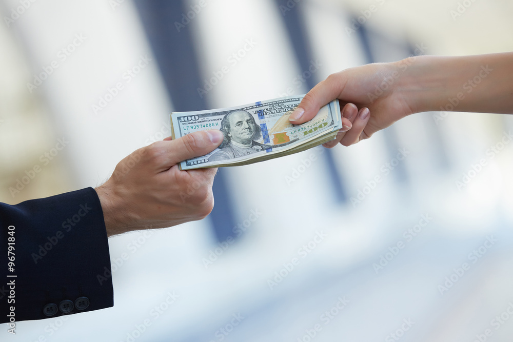 Wall mural business woman and a businessman hold money