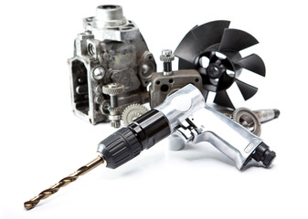 Car repair - details of the pump of high pressure and air drill on white background..