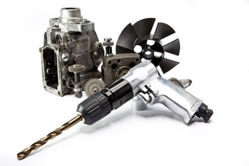 Car repair - details of the pump of high pressure and air drill on white background..