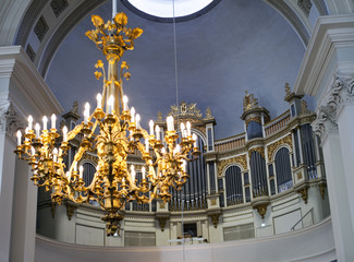 organ in Helsinki Lutheran cathedral (St. Nicolas church) and chandelier out of focus, Finland..
