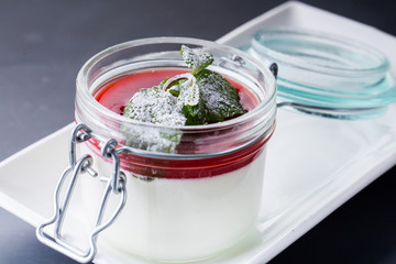 Vanilla panna cotta with strawberry sauce and mint