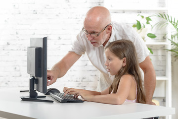  teacher and a school girl with a computer