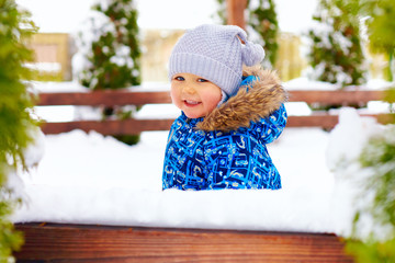 cute little baby boy on the winter walk in park