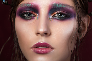 Beauty portrait of a young girl with fashion creative make-up