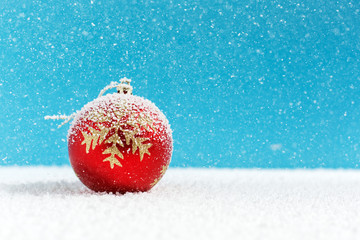 Christmas balls on snow, falling snow
