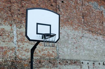 Basketball net in front of a old brick wall 