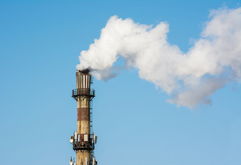 Close up of White industrial smoke  from dirty chimney.