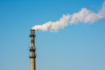 Close up of White industrial smoke  from dirty chimney.