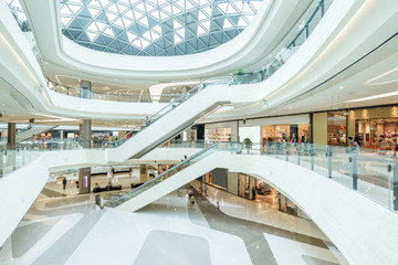 abstract ceiling and escalator in hall of shopping mall - Powered by Adobe