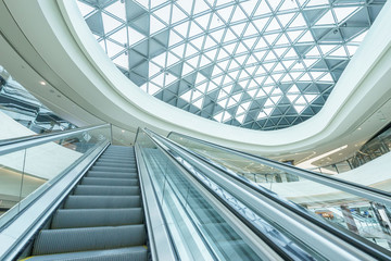 abstract ceiling and escalator in hall of shopping mall