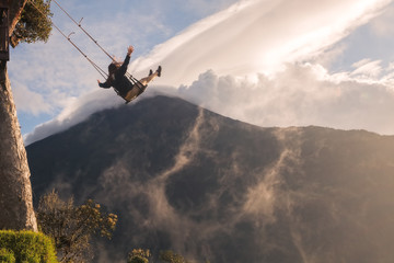 Silhouette Of An Young Happy Woman On A Swing