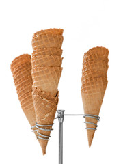 Ice cream waffle cones on dispenser isolated on white