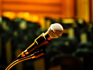 Closeup microphone in meeting room or conference room with blurred light background for business...