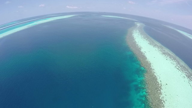 AERIAL: Luxury island resort on exotic white sand beach, Maldives.
