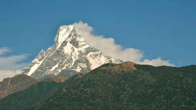 Clouds running down the Machapuchare in Nepal, time-lapse cinemagraph seamless loop