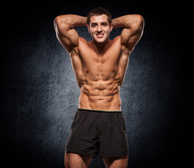 Fototapeta na wymiar Muscular Bodybuilder Guy Doing Exercises With Dumbbells