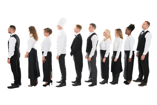 Side View Of Restaurant Staff Standing In Line