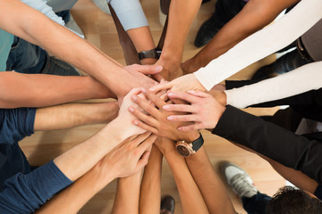 Creative Business People Piling Hands Over White Background