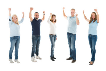 Obraz premium Confident People In Casuals Standing With Arms Raised