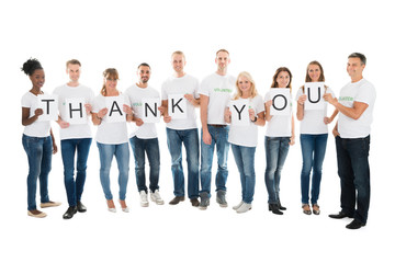 Confident Volunteers Showing Thank You Sign