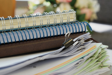 Three notebooks and stack of document