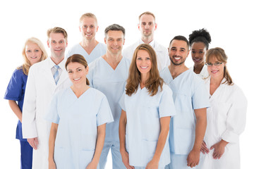 Happy Medical Team Standing Against White Background