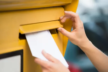 Foto op Plexiglas Woman's Hands Inserting Letter In Mailbox © Andrey Popov