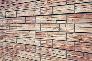 A decorative stone artificial covering in the form of red bricks