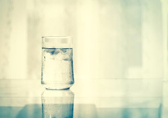 glass of Cool fresh drink with ice cube on the  table 