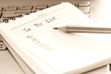 close up Handwritten to do list plan in small note book , vintag