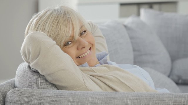 Portrait of senior woman relaxing in sofa