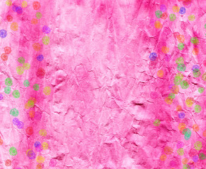 Texture of the wrinkled paper as a background. Pink color, small colored abstract flowers.