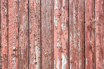Red painted peeling paint wooden desks texture.