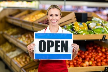 Smiling woman holding sign