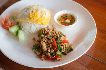 Rice topped fried egg with stir-fried pork and basil