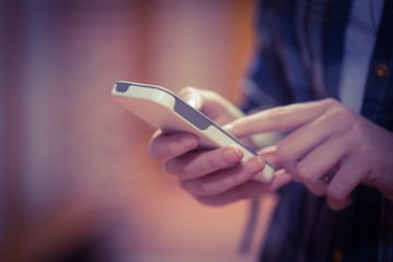 Standing student using smartphone