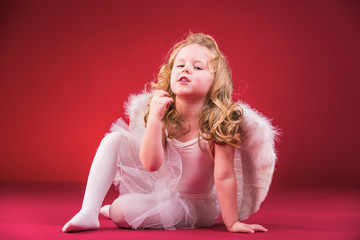 Beautiful blond hair angel on a red background