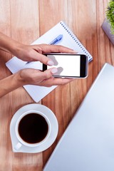 Overhead of feminine hands using smartphone